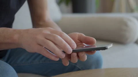 Man applying protective glass screen protector to smartphone at home Stock Footage 330396287