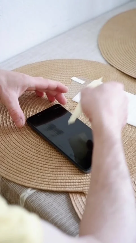 Man applying a screen protector film Stock Footage 338008612