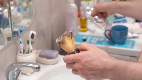 Man applying shaving foam to a brush Stock Footage 128889987