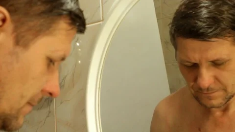 Man is applying shaving foam to his face Stock Footage 82467183