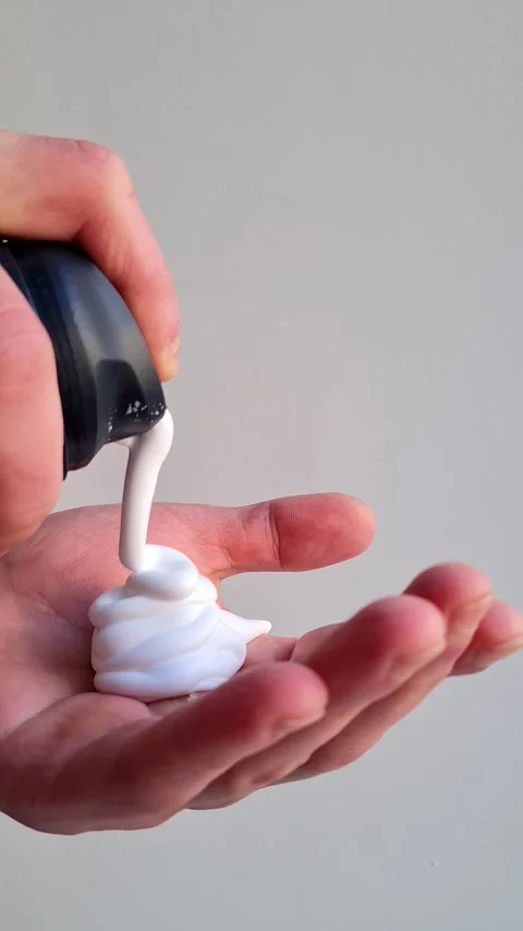 Man applying shaving foam to his hand Stock Footage 296965312