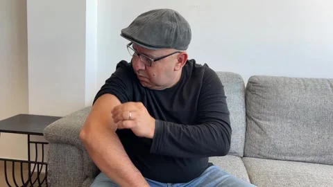 Man applying smart glucose patch while checking smartphone Stock Footage 332793795