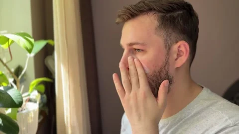 Man applying SPF cream to face for sun protection Stock Footage 311313944
