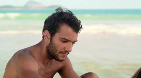 Man applying sunscreen lotion on woman's back at Ipanema beach Stock Footage 59376632