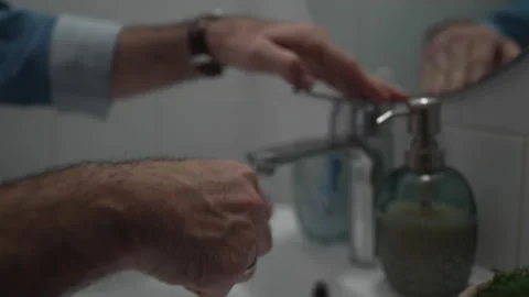 Man applying toothpaste to toothbrush in bathroom Vídeos de archivo 336624635