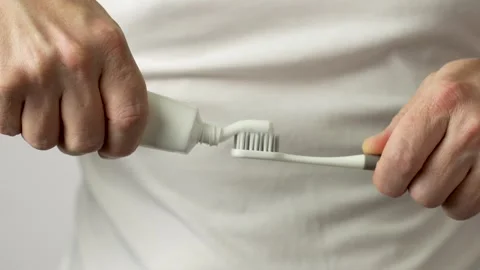 Man applying toothpaste on a toothbrush, close-up Stock Footage 253252729
