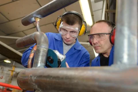 Man as apprentice works in teamwork Stock Photos