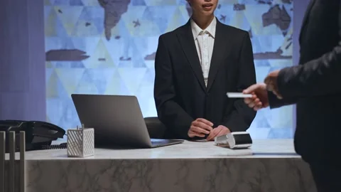 The man approached the receptionist and pay by card at the terminal Stock Footage 233994650