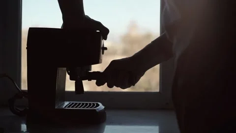 The man approaches the coffee machine and takes the filter holder and installs Stock Footage 201291736