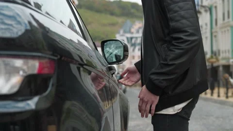 Man approaches a his car, pulls the door handle, realizes that he forgot the key Stock Footage 143425231