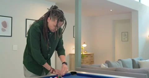 Man is approaching blue-felt pool table, lifting black rack and arranging balls Stock-Footage 343098436