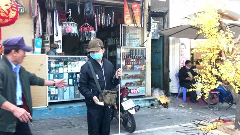 Man approaching to help a blind young man cross the street on Tet holiday Video stock 146766629