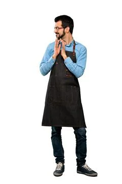 Man with apron scheming something Stock Photos