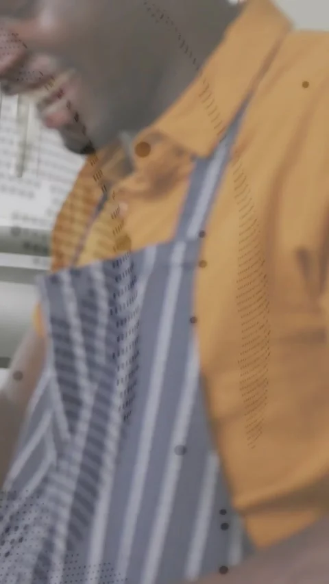 Man in apron scooping in kitchen, lifting spoon tasting for seasoning with Stock Footage 331383304