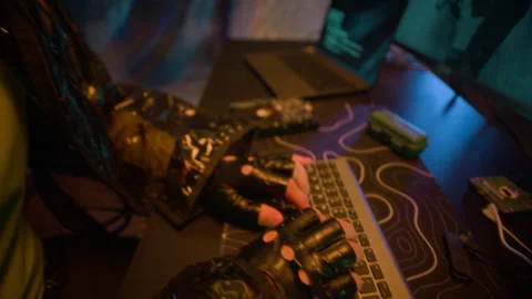 Man in AR Visor Launching Hack on Computer in Dark Cyberpunk Office Stock Footage 327637025