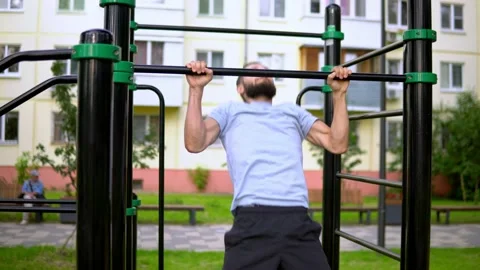 A man of Arab appearance on pull -up bars does exercises. Stock Footage 199422103