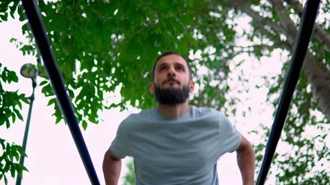 A man of Arab appearance on pull -up bars does exercises. Stock Footage 199422215