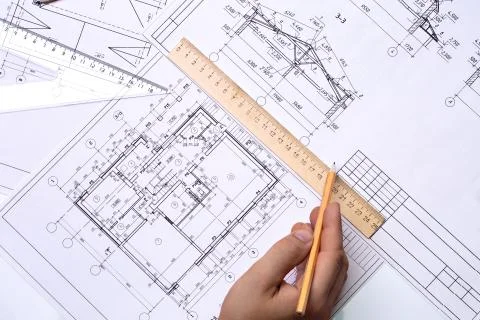 Man architect draws a plan, schedule, design, geometric shapes with a pencil Stock Photos