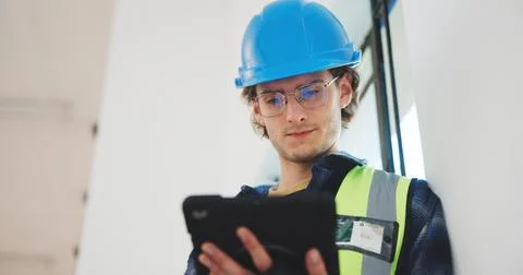 Man, architect or construction with tablet in building for renovation, safety or Stock Photos