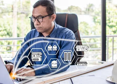 Man architect using a laptop Computers to design and calculate the construc.. Stock Photos