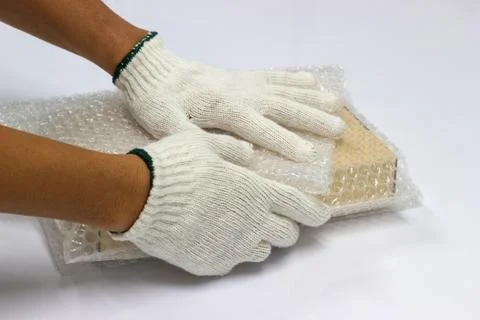 Man are using a bubble wrap wrapped Packing and protection brown box Stock Photos