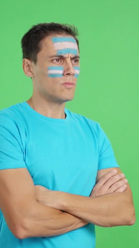 Man with argentine flag painted looking away with serious expression Video stock 273966199