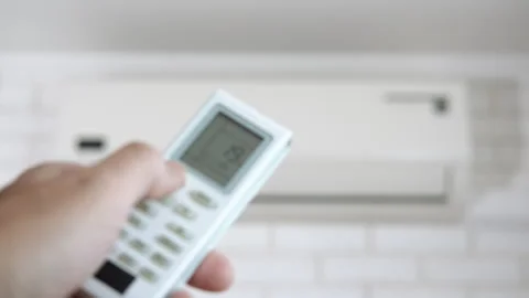Man arm with remote power by air conditioner. Stock Footage 306583765