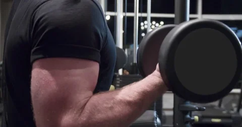 Man arm training biceps with dumbbells 4k close-up video. Gym weight exercise Stock Footage 71800734
