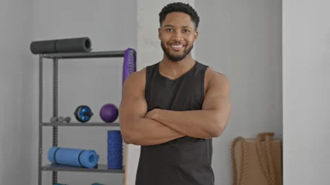 Man with arms crossed showing bare biceps in studio during training, smilin.. Stock Footage 337440193