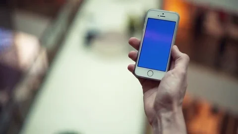 Man arms using smartphone with blue display in shopping mall Stock Footage 82989926