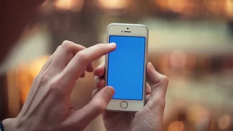 Man arms using smartphone with blue screen in shopping center Stock Footage 82990086