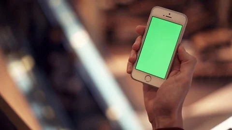 Man arms using smartphone with green display in shopping mall Stock-Footage 82990511