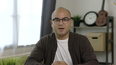 A man around the age of 35. Working at home by meeting video conference looking  库存影片 153023764