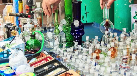 Man Arranges Hookahs Jars on Mobile Counter in Street Stock Footage