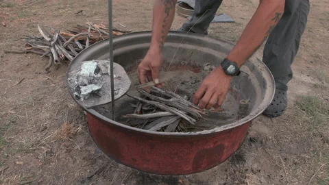 Man arranges kindling getting it ready to start a campfire Stock Footage 240059964