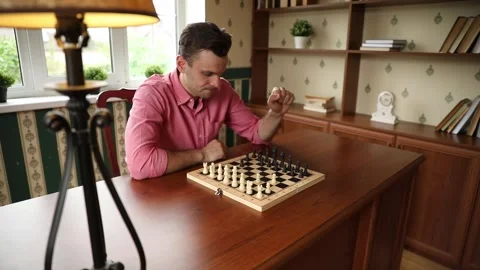 Man Arranging Chess Pieces Before Game at Home Stock Footage 332639760