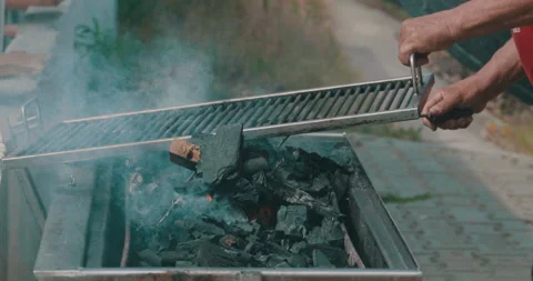Man Arranging the Coals Stock Footage 161908691