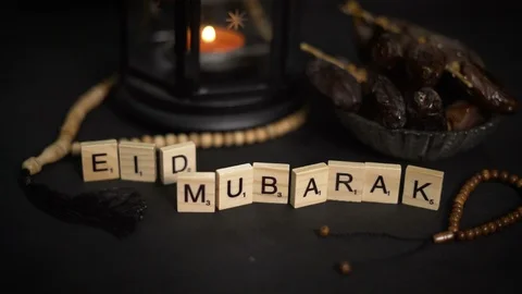 Man Arranging Eid Mubarak Greeting Wooden Letters. Ramadan Candle Lantern wit Stock Footage 89972431