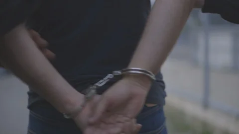 Man is Arrested and Led to a Police Car by Two Officers HD Video Stock Footage 92028817