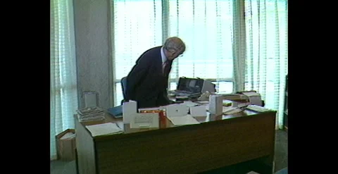 Man Arrives at Work to Use Early Desktop Computer (1984) Stock Footage 310870067