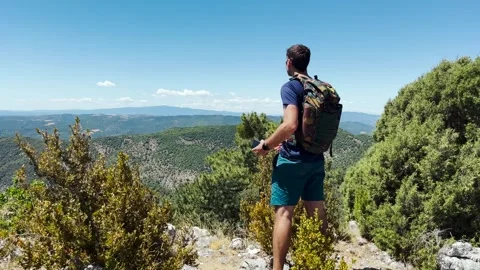 Man arriving at Mountain Viewpoint and Photographing Landscape With Smartphone Stock Footage 338007383