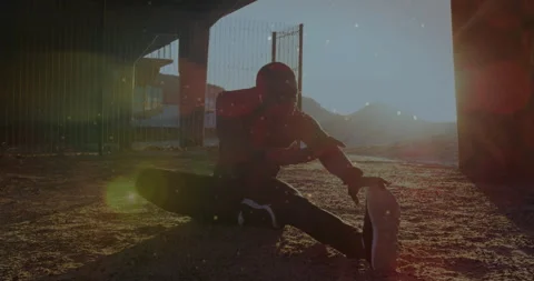 Man arriving under metal structure then shifting into hamstring stretch for Stock Footage 311507625