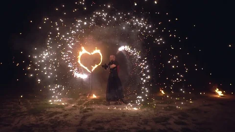 Man artist twist fire objects in his hands sparkling fire show with burning Stock Footage 99042726
