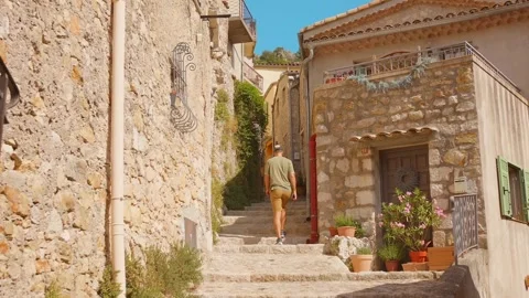 Man Ascending Stone Steps in Historic Sainte-Agnes Village, South of France Vídeo Stock 348348652