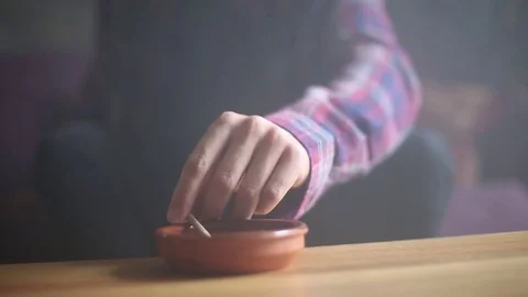 Man Ashes Cigarette in Ashtray Stock Footage 78198042