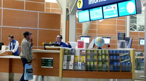 Man asking direction at informtion center inside YVR airport Stock Footage 60361165