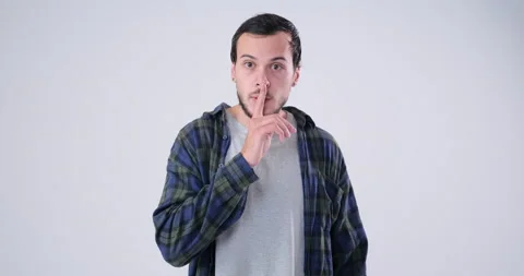 Man asks be quiet with finger on his lips 動画素材 143942195