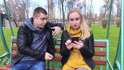 The man asks the woman to put down the phone and talk to him. The girl on a date Stock Footage 152234939
