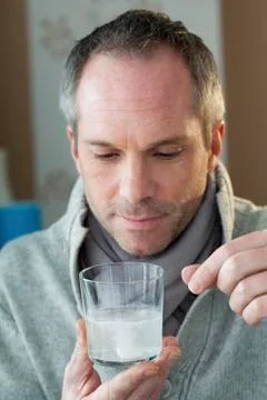 Man with aspirin Stock Photos