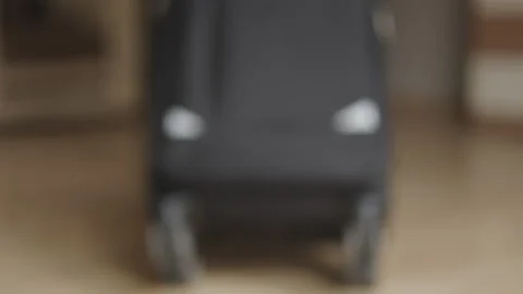 A man with an assembled suitcase going out. travel and travel, business trip Stock Footage 239931214
